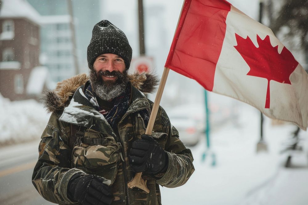 Man holding a flag of canada winter adult snow. AI generated Image by rawpixel.