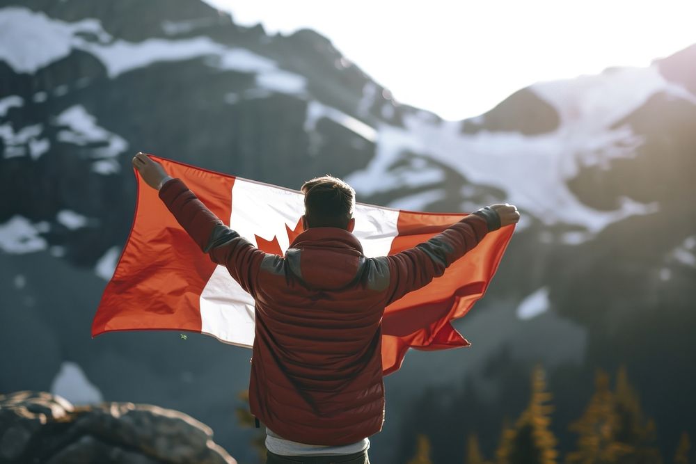 Man holding in canadian flag adult patriotism happiness. AI generated Image by rawpixel.