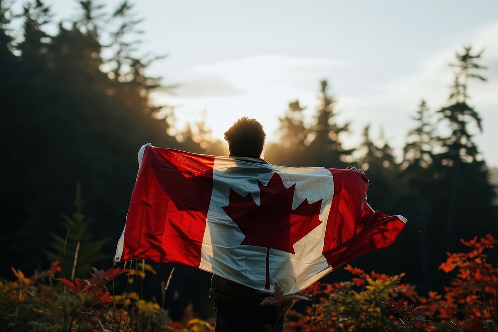 Man holding in canadian flag patriotism outdoors standing. AI generated Image by rawpixel.