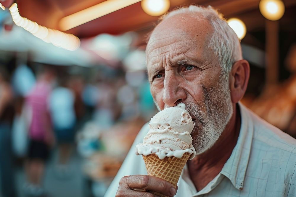 Man eating ice cream cone dessert adult food.