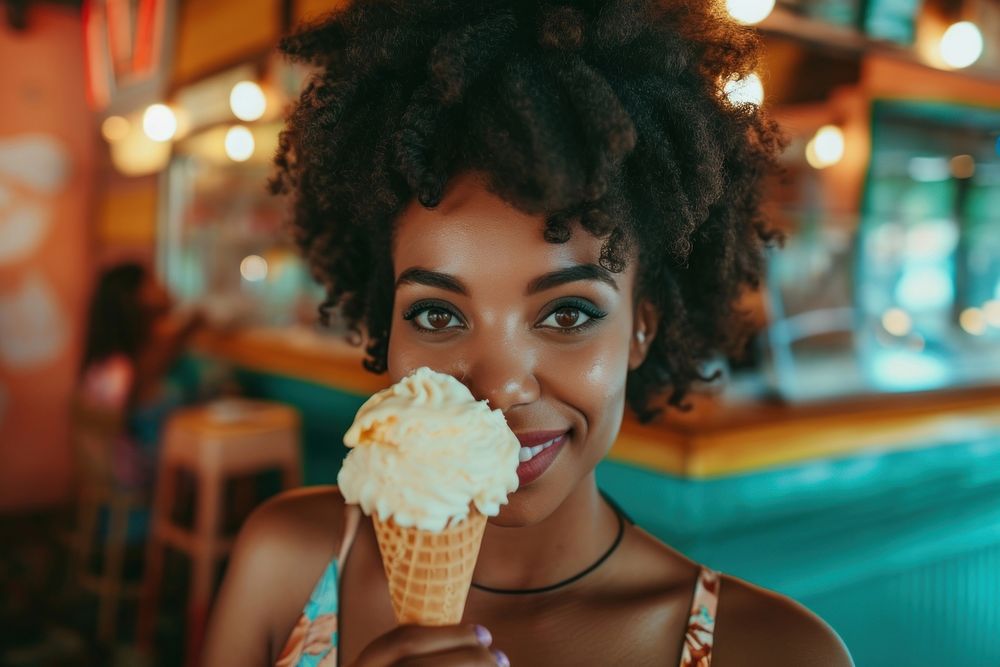 Woman eating ice cream cone dessert biting food.