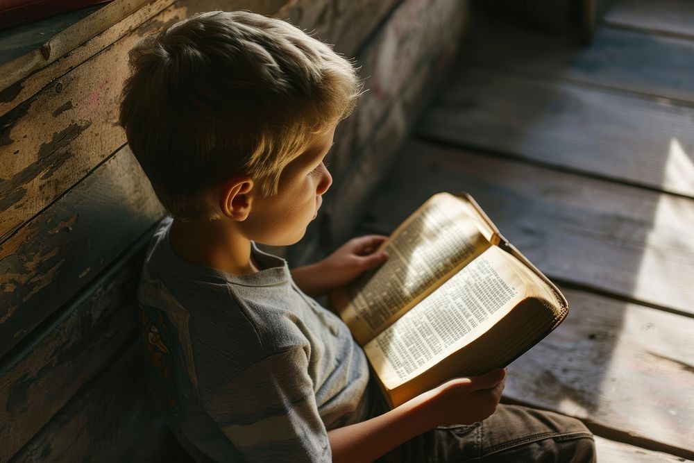 Boy reading the bible publication child book. AI generated Image by rawpixel.