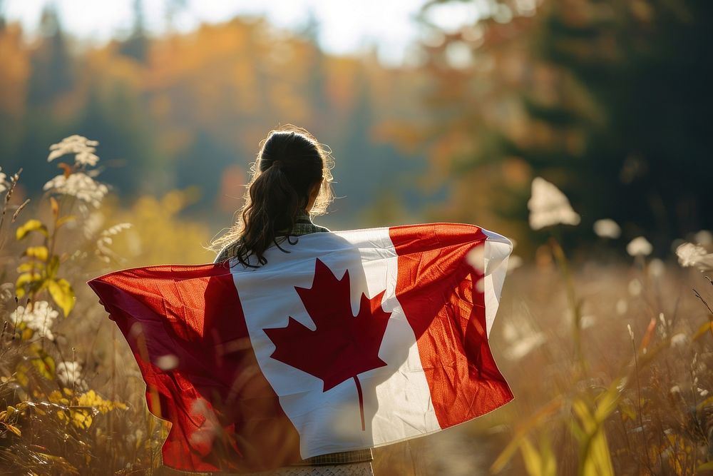 Woman holding in canadian flag adult patriotism sunlight. AI generated Image by rawpixel.