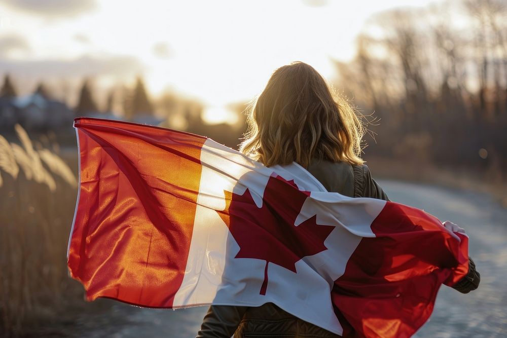 Woman holding in canadian flag patriotism hairstyle sunlight. AI generated Image by rawpixel.
