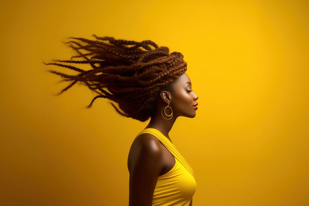 Shaking beautiful Afro braids yellow adult photo.
