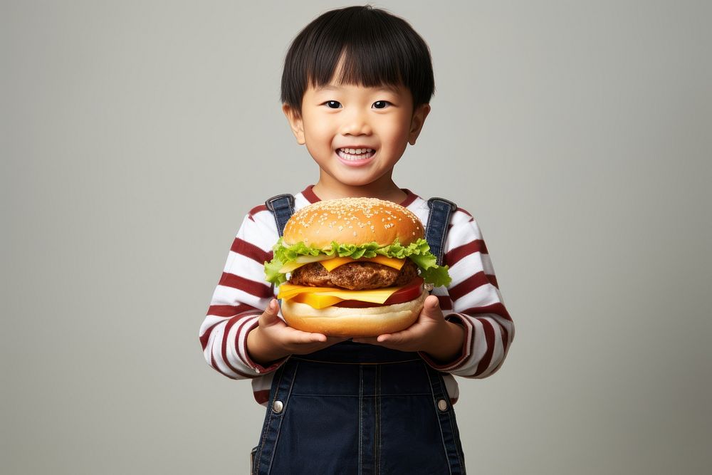 Hongkonger little boy eating burger child food face.
