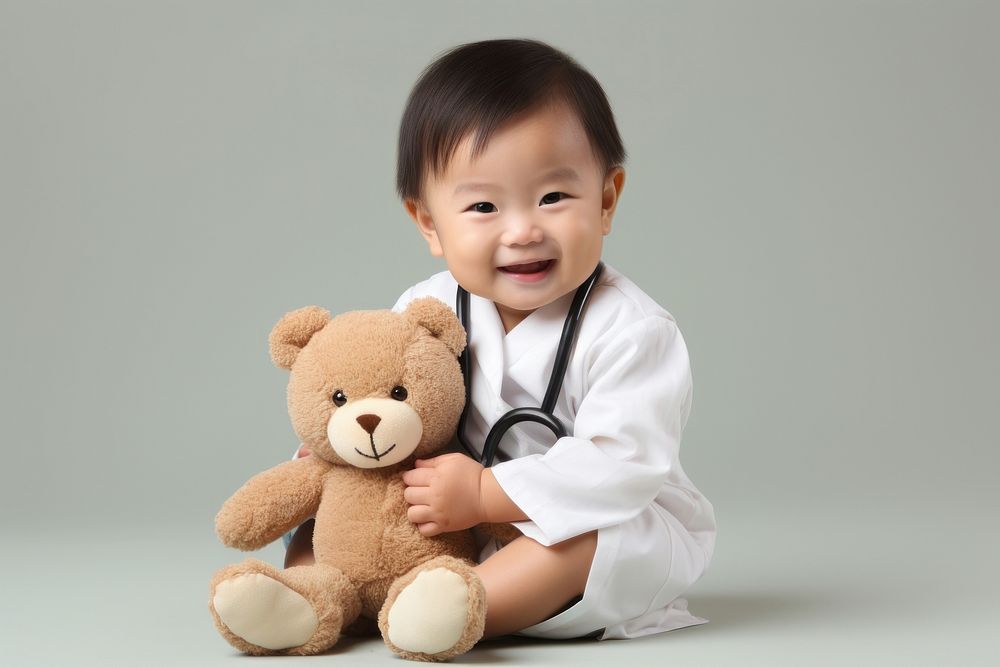 Japanese little boy with stethoscope toy portrait sitting photo.