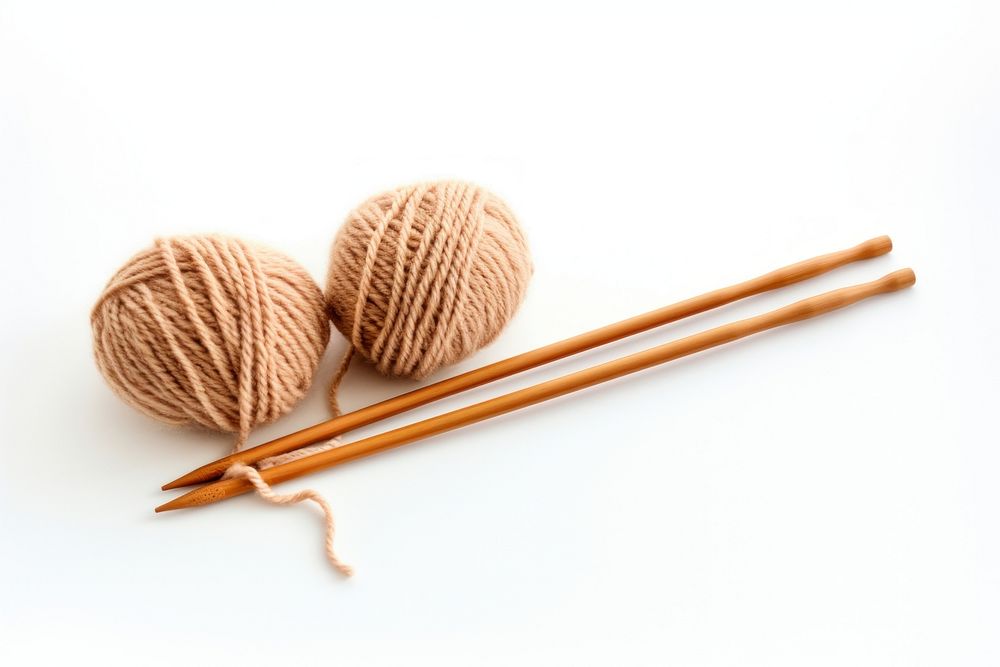 Soft wool yarn and two knitting needles chopsticks white background xiaolongbao. AI generated Image by rawpixel.
