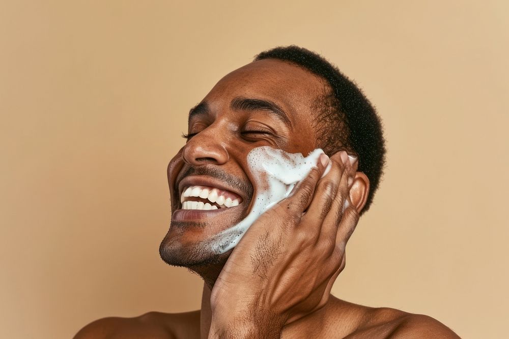 Man using facial wash laughing portrait adult.