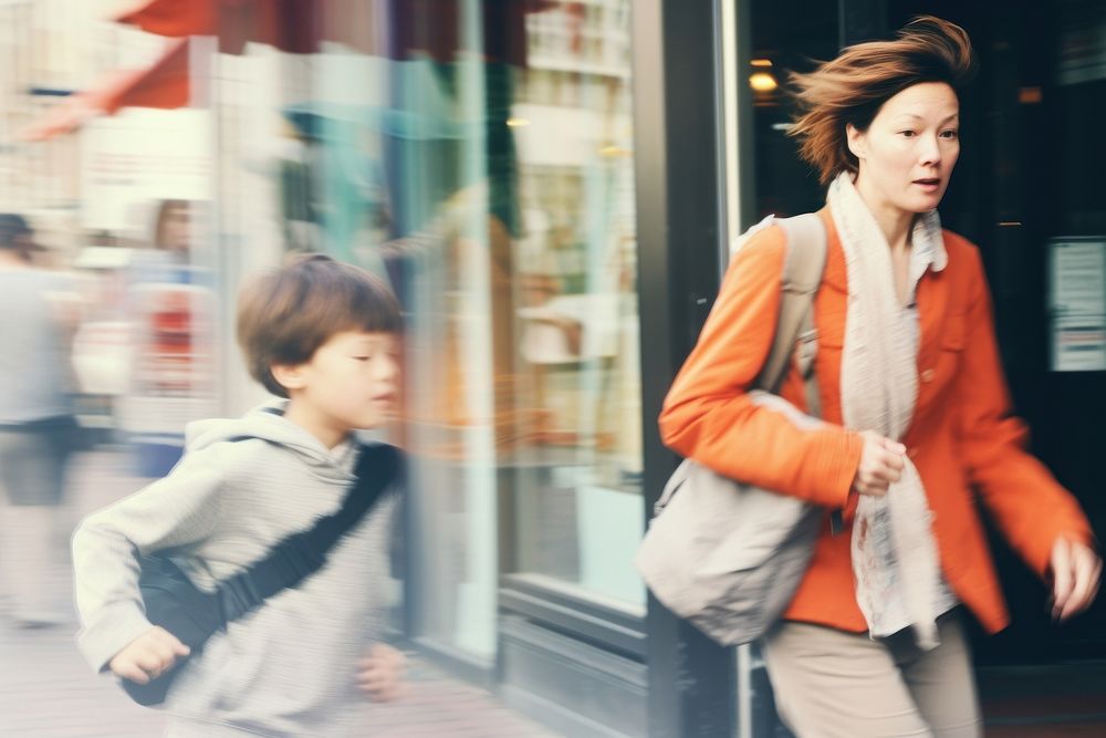 Motion blur mom and son slowly walking on street portrait adult child.