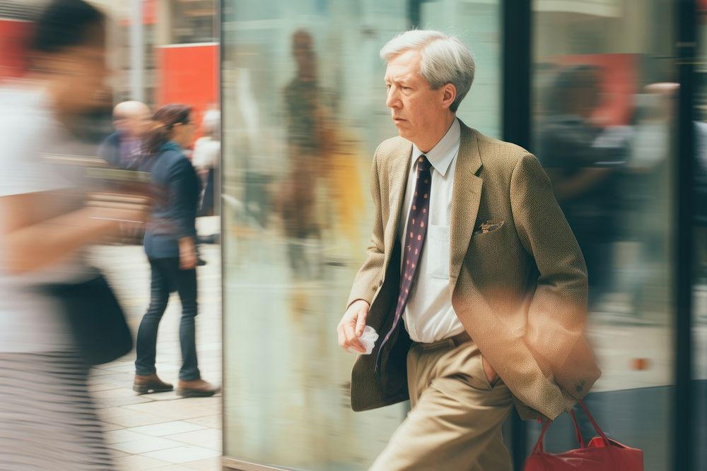 Motion blur old businessman walking and talking on a phone portrait adult men.