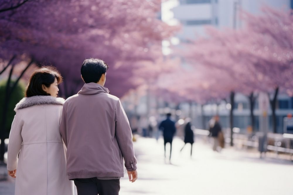 Couple walking on tokyo street autumn day blossom flower plant.