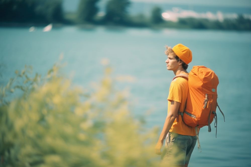 Backpacker on lake shore photography walking motion. AI generated Image by rawpixel.