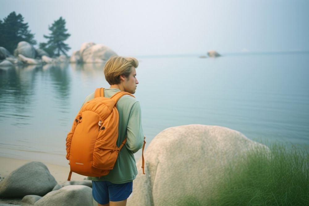 Backpacker on lake shore photography walking adult. AI generated Image by rawpixel.
