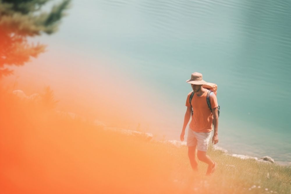 Backpacker on lake shore photography walking motion. AI generated Image by rawpixel.