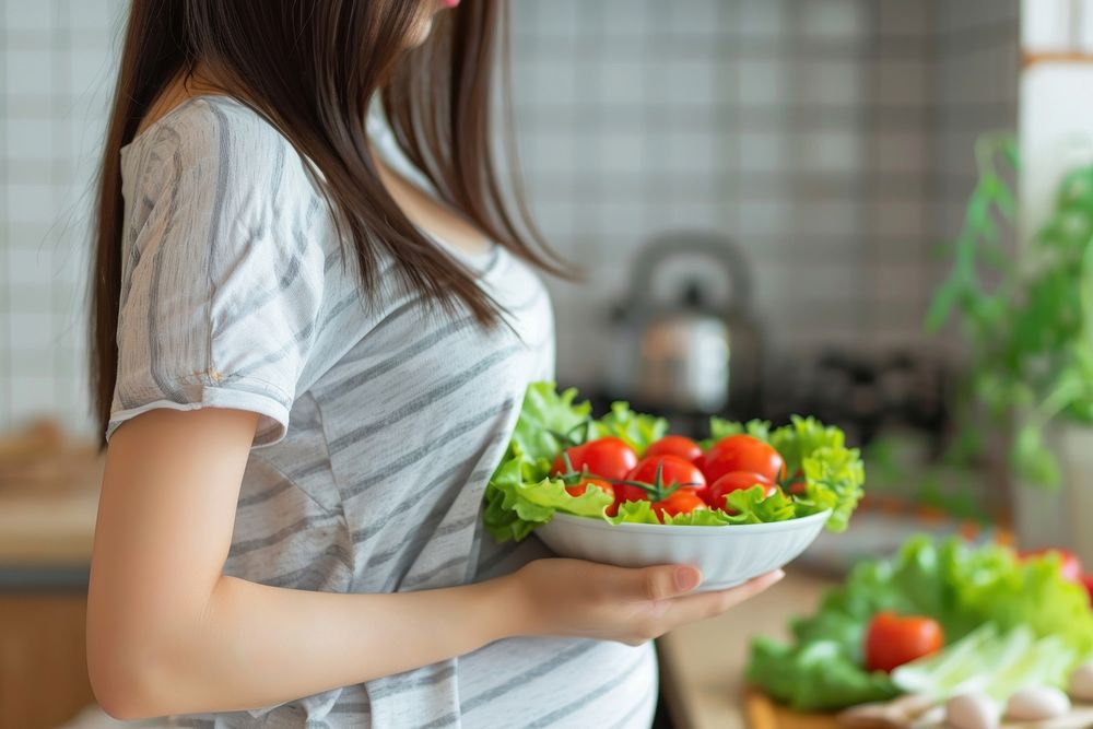 Pregnant asian woman eating healthy food salad anticipation midsection. AI generated Image by rawpixel.