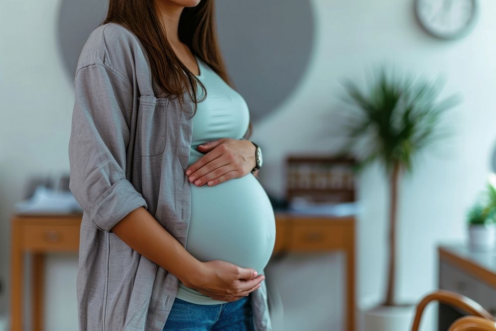 Pregnant woman in clinic anticipation beginnings midsection. AI generated Image by rawpixel.