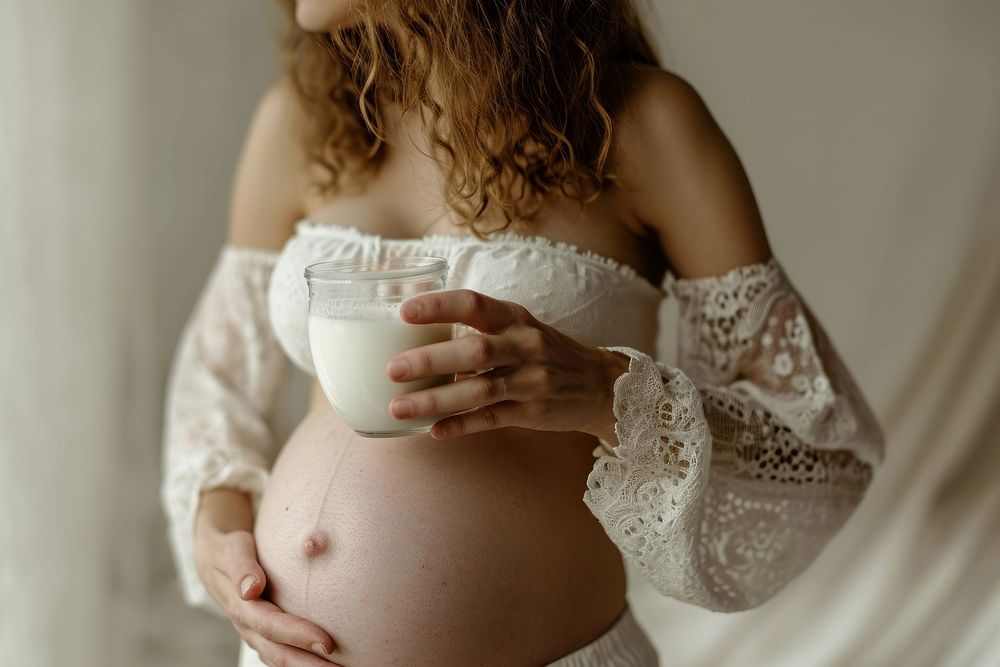Woman drinking milk during her pregnancy hand anticipation refreshment. AI generated Image by rawpixel.