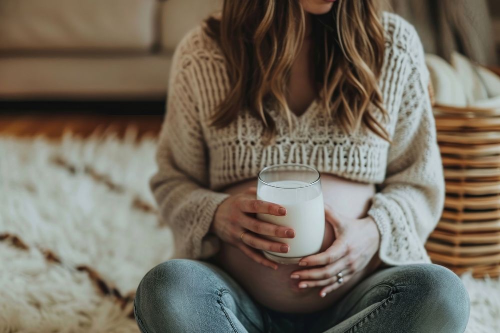 Woman drinking milk during her pregnancy anticipation beginnings relaxation. AI generated Image by rawpixel.