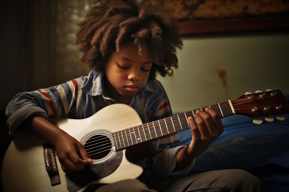 African American kid guitar musician playing guitar.