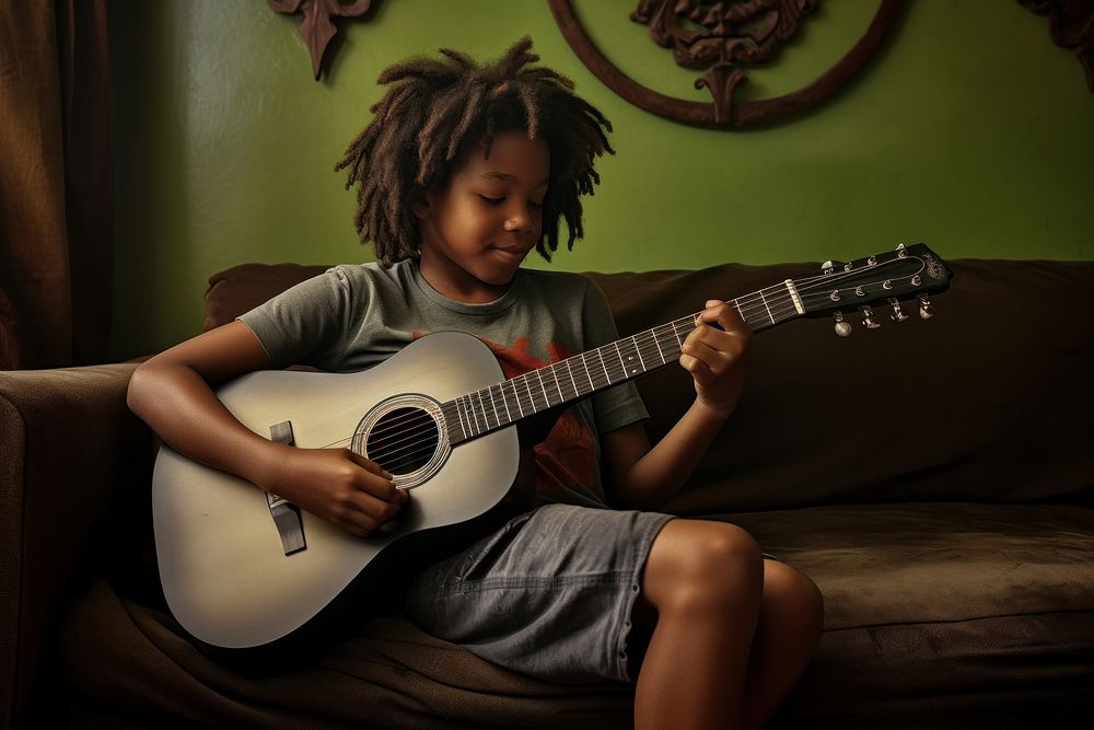African American kid guitar musician playing guitar.