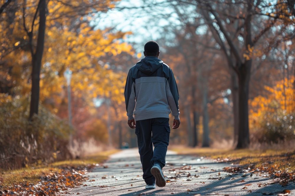 African American walking autumn nature.