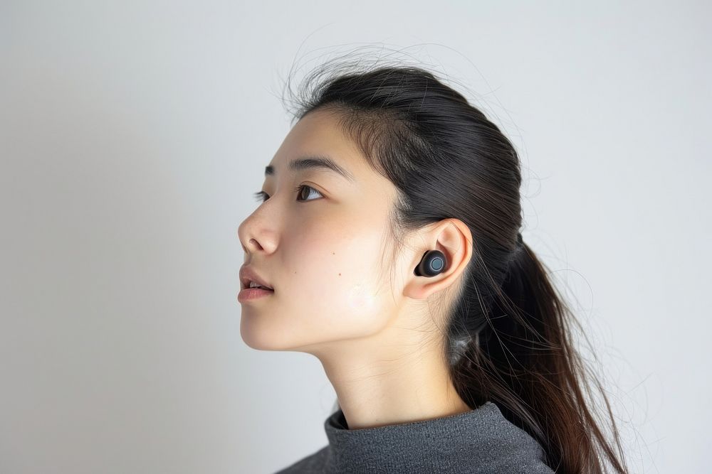 Asian woman with wireless earbuds photography portrait jewelry.