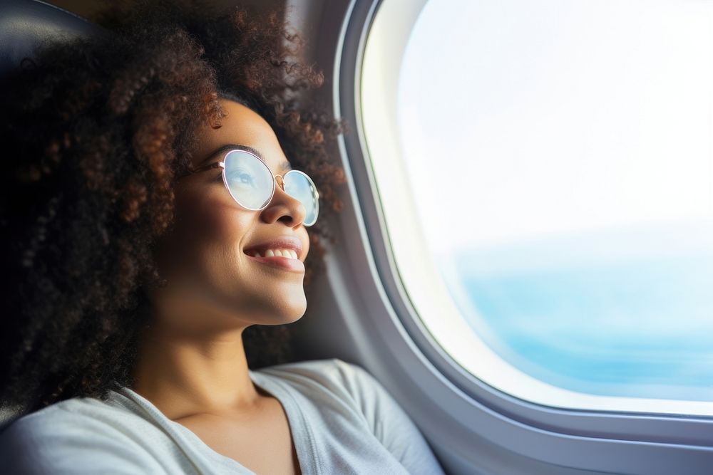 Middle age african american woman portrait sunglasses airplane.