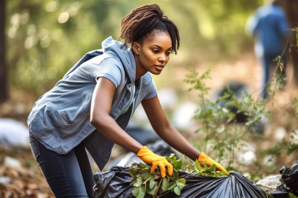 African american woman volunteering gardening cleaning outdoors.