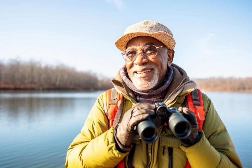 Happy senior african american traveler binoculars standing portrait.