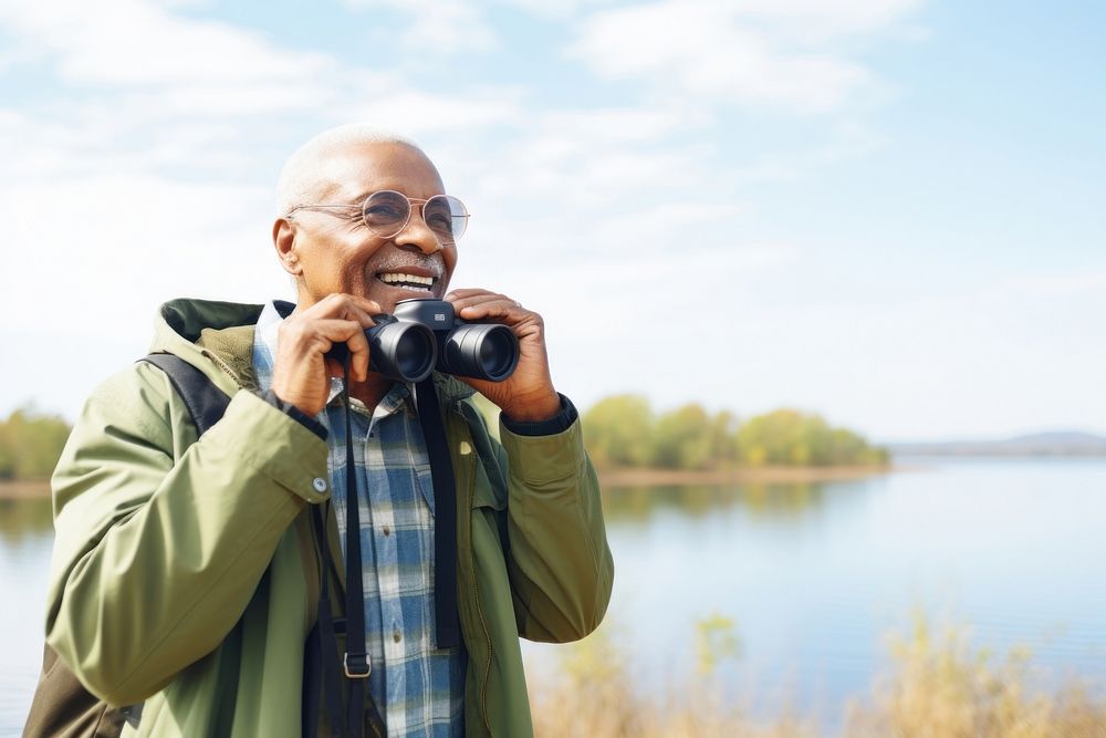 Happy senior african american traveler binoculars standing portrait.