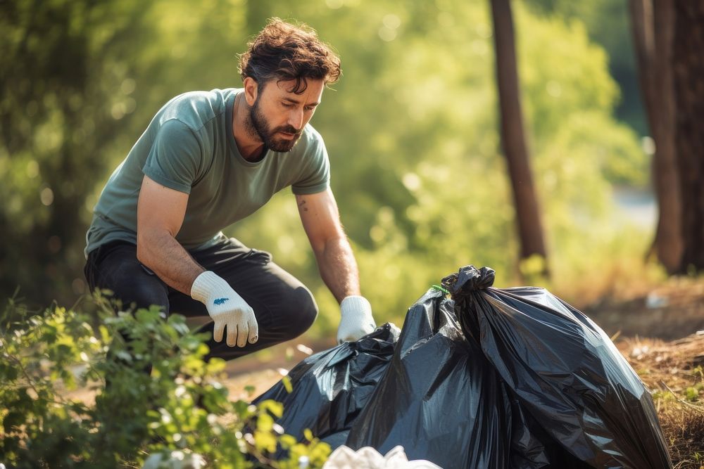 Latin man volunteering garbage adult protection.