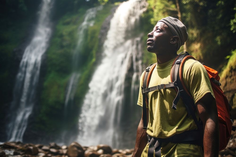Middle age african american backpacker waterfall adventure portrait.