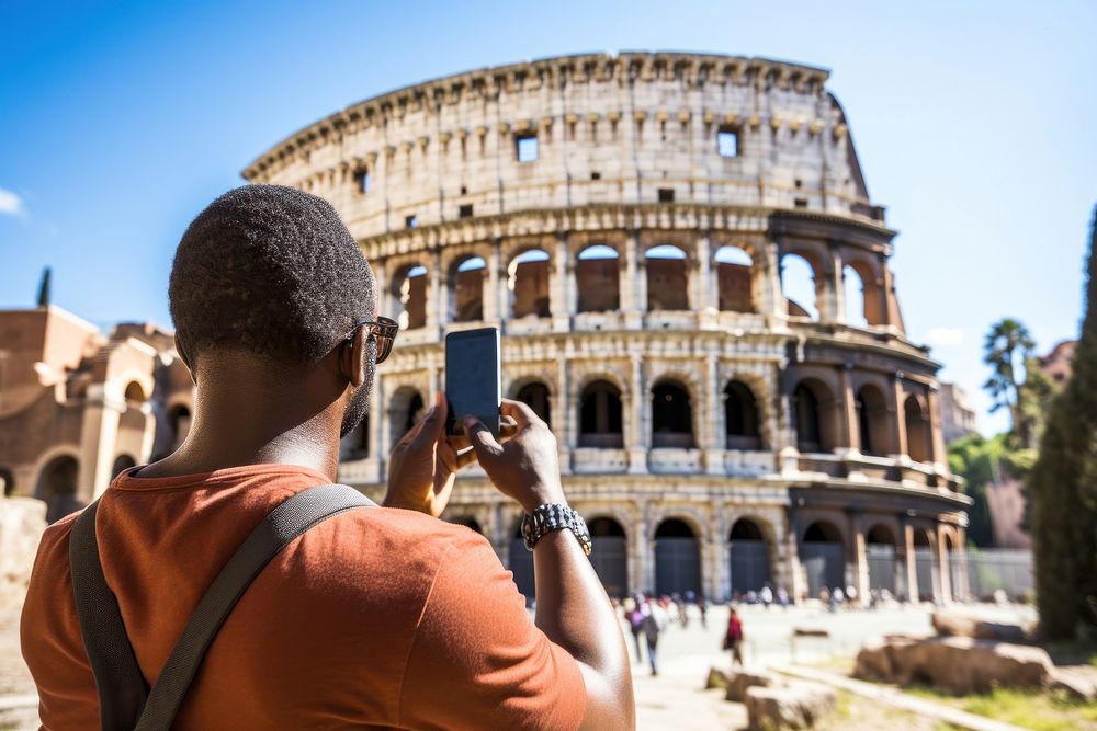 Middle age african american traveller colosseum landmark selfie.