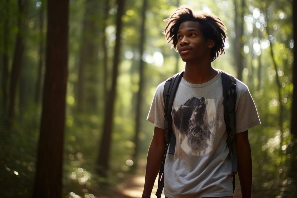 African American teen man forest portrait outdoors.