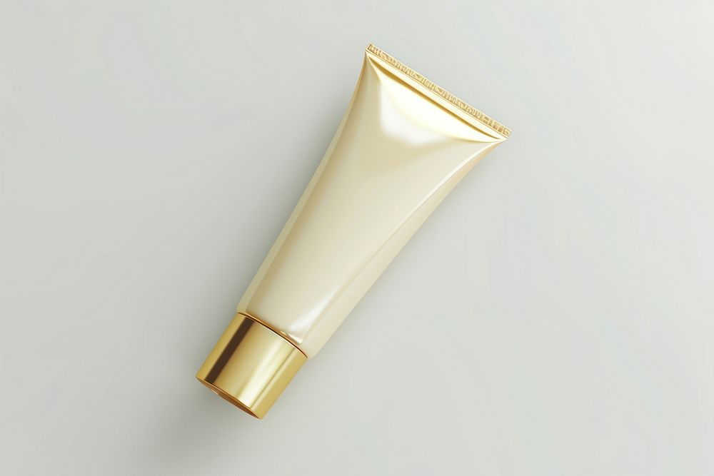 Cream tube cosmetics gold white background.