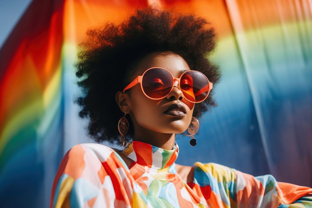 Young black woman wearing a large glass sunglasses red vibrant color hairstyle.
