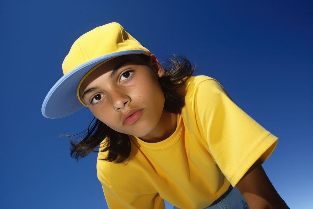Hispanic young boy playing sports portrait yellow photo.