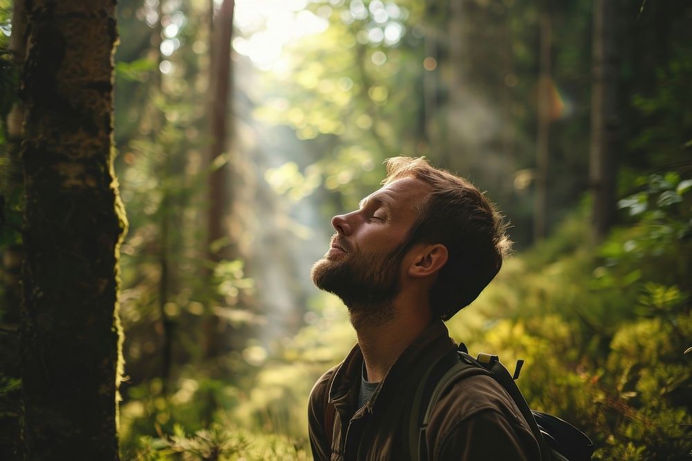 Relaxed adult man forest tree portrait. 