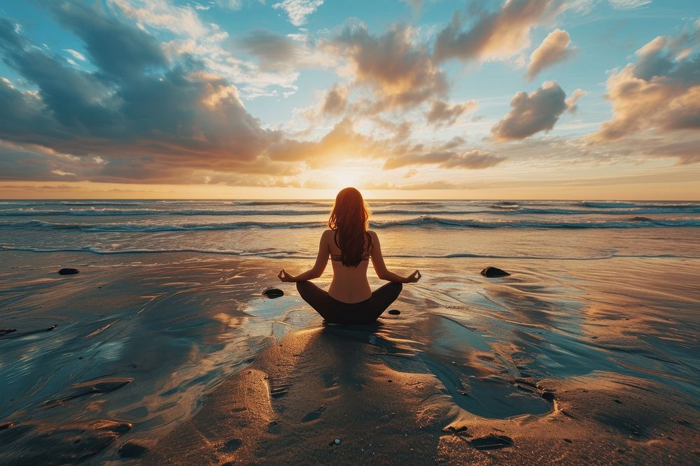 Young yoga woman outdoors sitting sunset. 