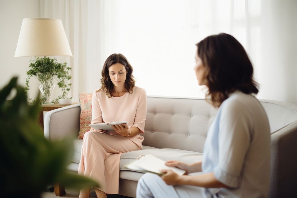 Woman sitting and having a consultation with a therapist conversation interview adult.