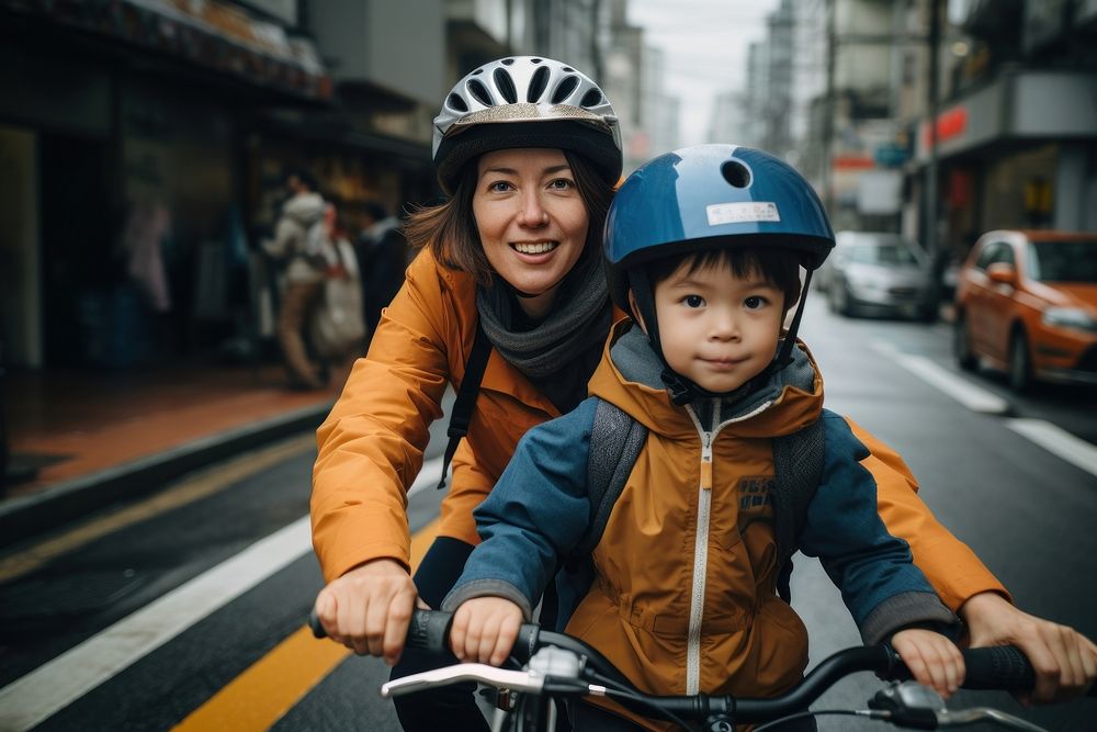 Mother rides bicycle and child crashes vehicle cycling helmet.