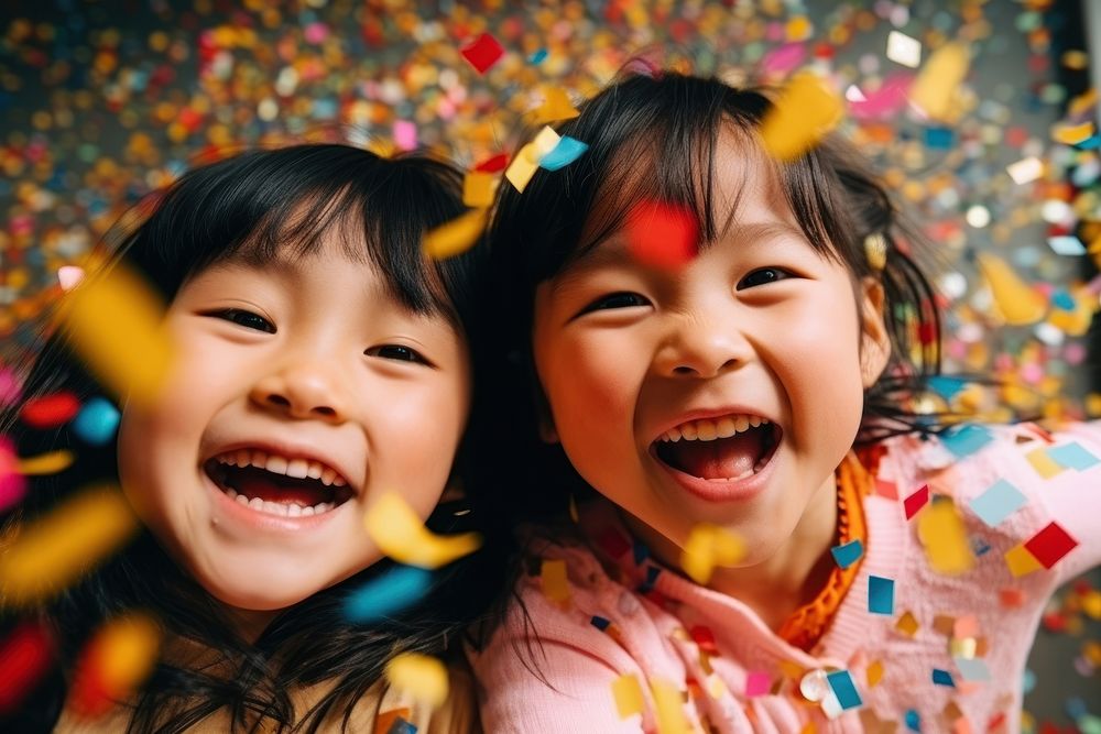 East Asians kids laughing portrait confetti.