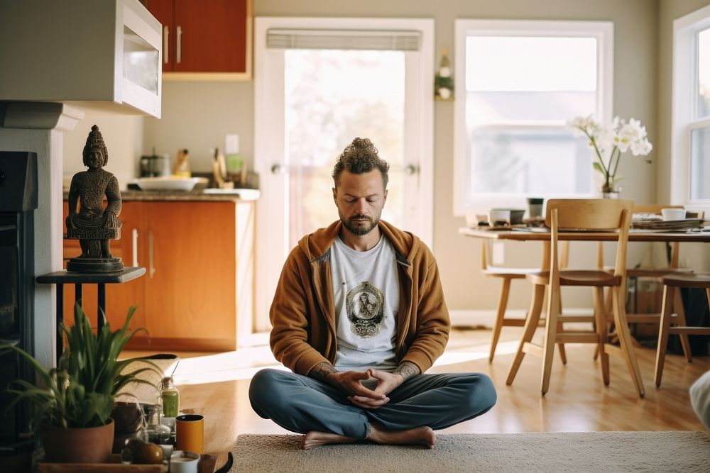 Adult man in morning meditation sitting yoga home.