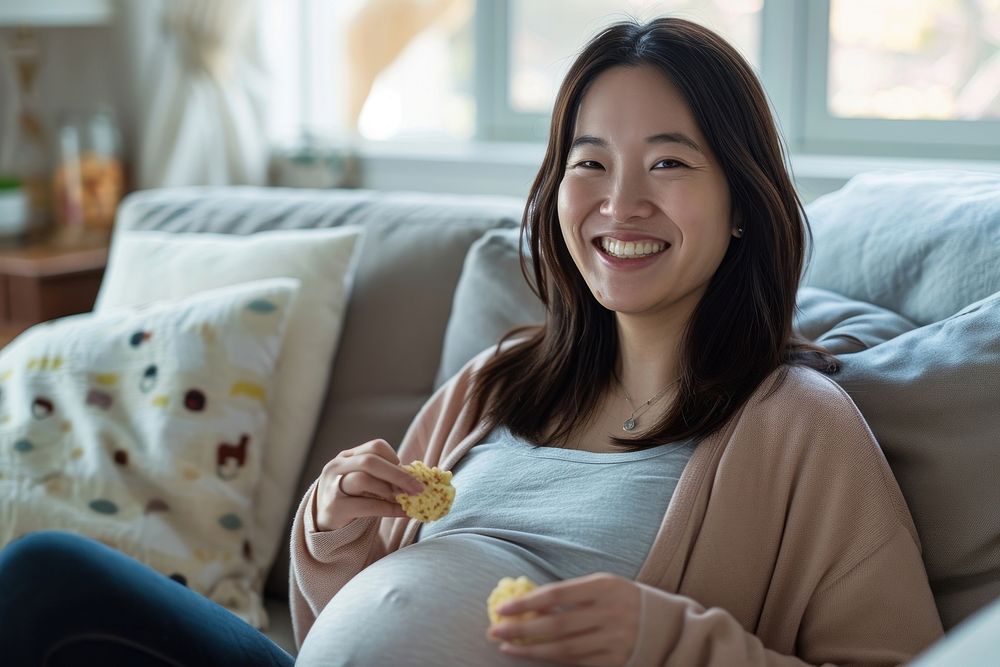 Pregnant asian woman smiling sitting smile.