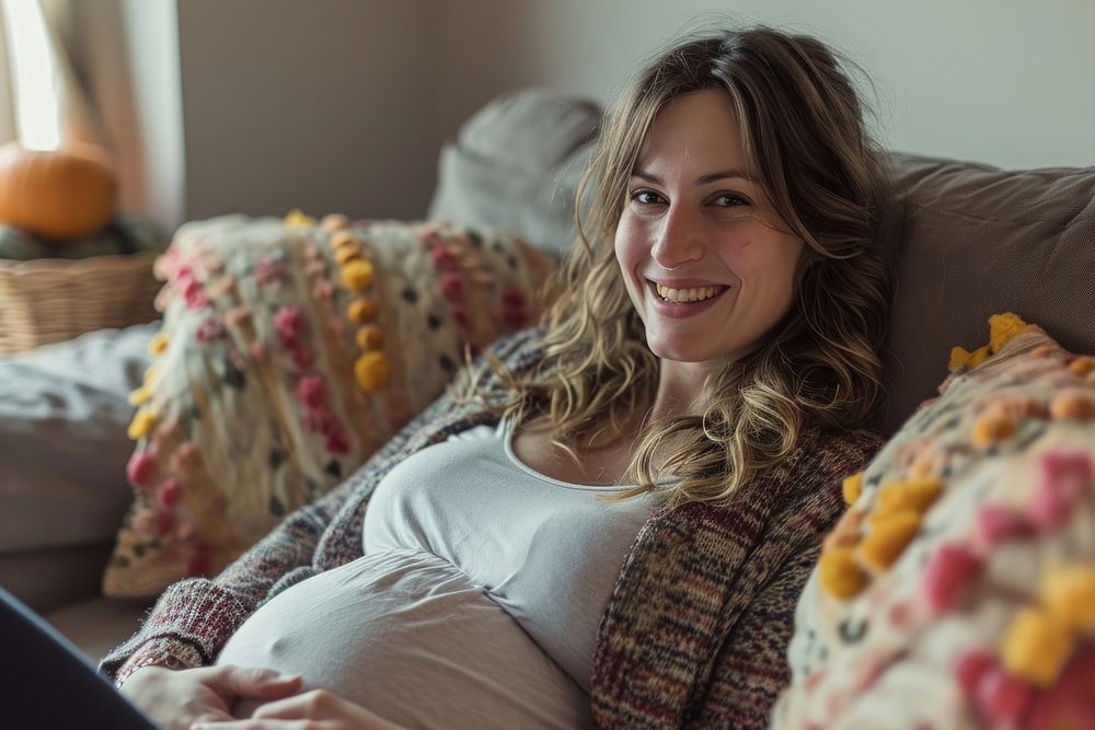 Pregnant british woman furniture portrait smiling.