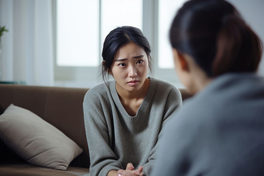Young chinese woman conversation worried talking. AI generated Image by rawpixel.