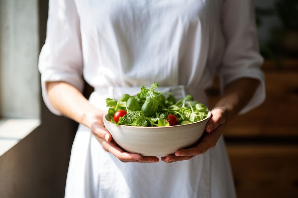 Hand holding a salad bowl kitchen adult woman. AI generated Image by rawpixel.