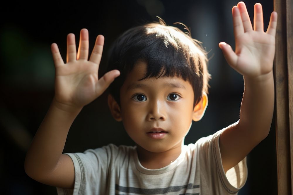 Raising one hand up child portrait photo.