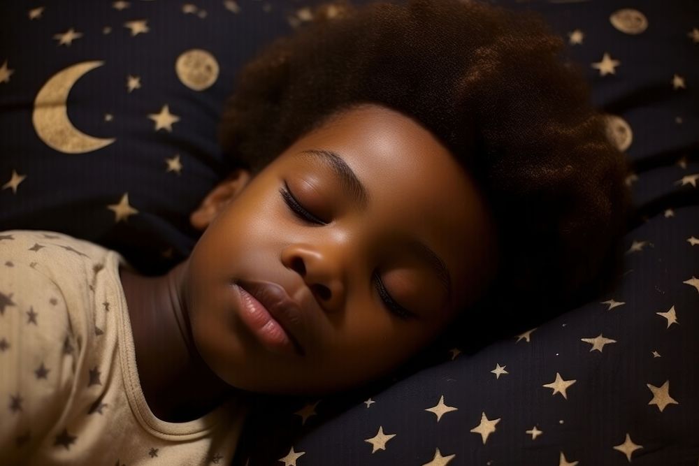 A sleeping black kid portrait bedroom photo.